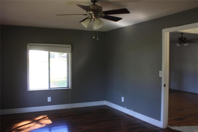 unfurnished room with dark hardwood / wood-style flooring and ceiling fan