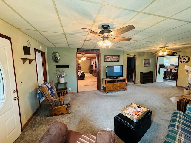 living room with carpet flooring and a paneled ceiling