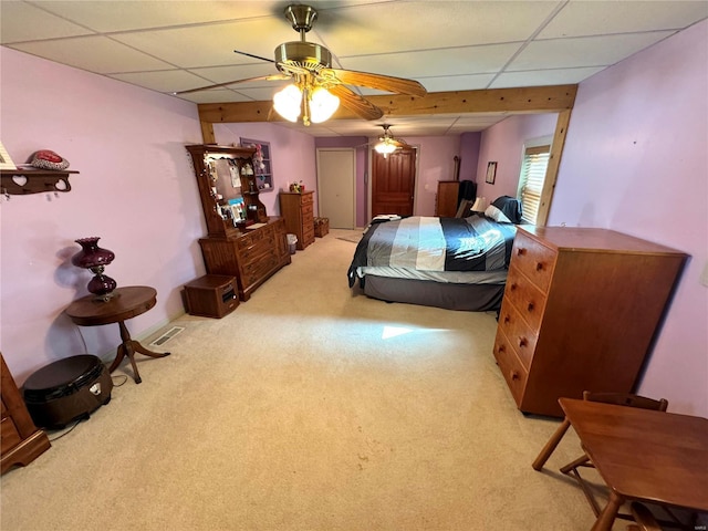 carpeted bedroom featuring ceiling fan and a paneled ceiling