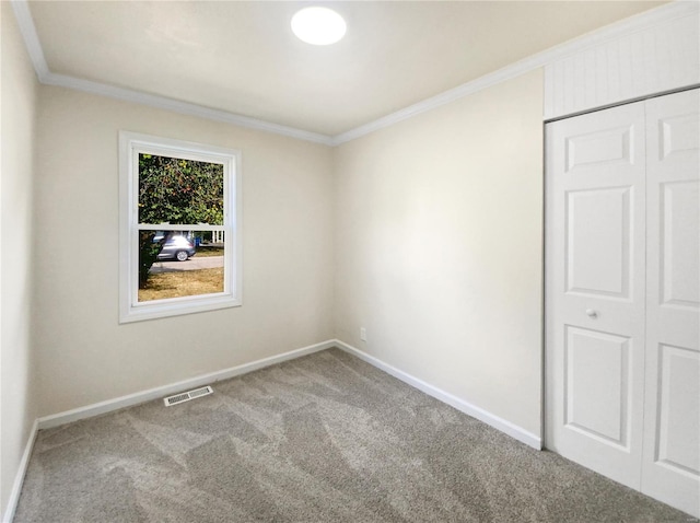 carpeted empty room featuring ornamental molding