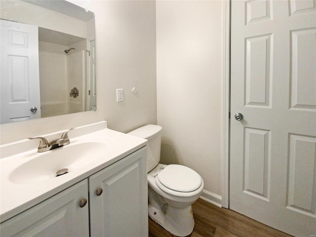 bathroom featuring a shower, vanity, toilet, and hardwood / wood-style flooring