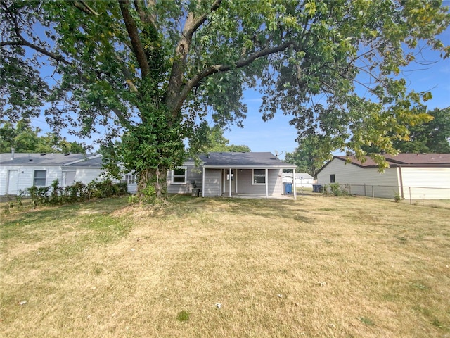 rear view of property with a lawn