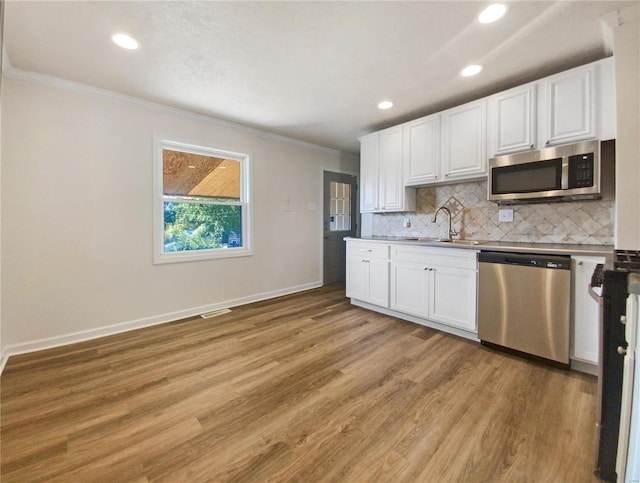 kitchen featuring light wood-type flooring, white cabinetry, and stainless steel appliances