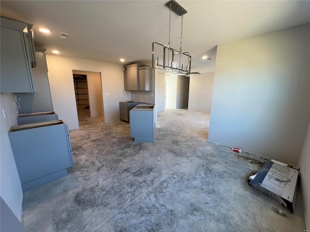 kitchen with gray cabinets and hanging light fixtures