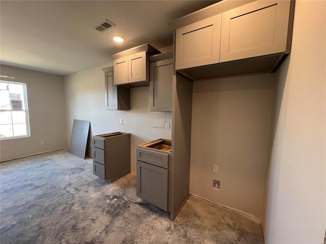 kitchen with carpet and gray cabinetry