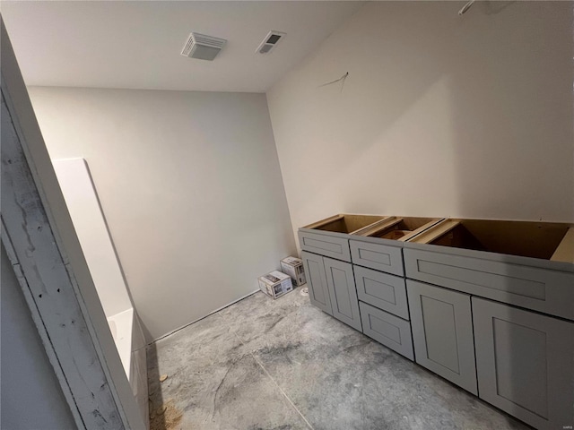 bathroom featuring a bath and concrete floors