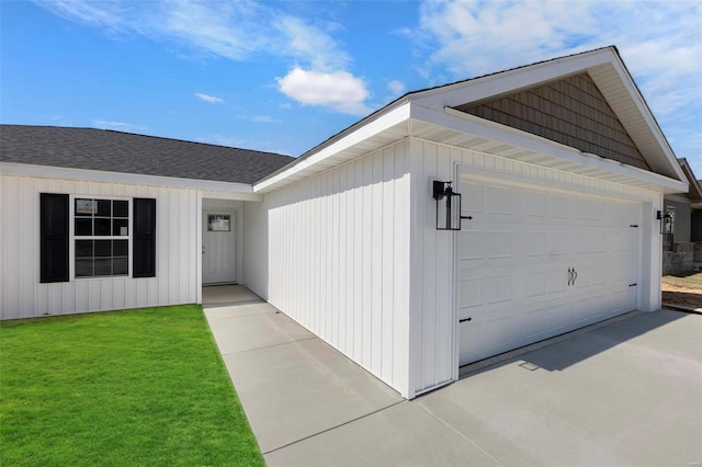 property entrance featuring a garage, a yard, and driveway