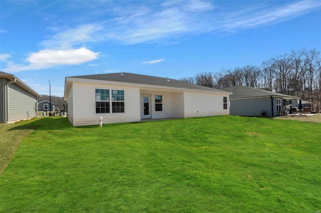 back of house featuring a lawn