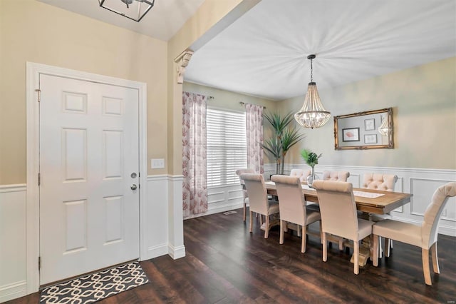 dining room featuring an inviting chandelier and dark wood-type flooring