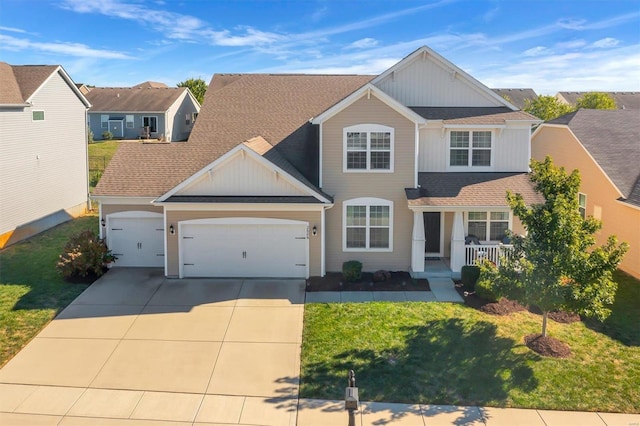 view of front of property featuring a front yard, a porch, and a garage