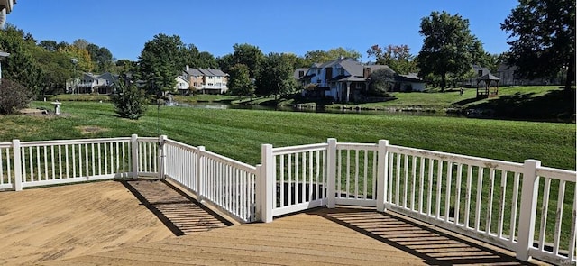 deck featuring a lawn and a water view