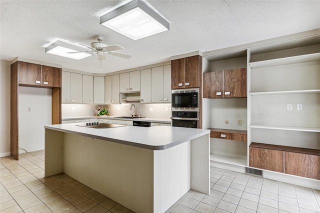 kitchen with sink, a center island, ceiling fan, and appliances with stainless steel finishes