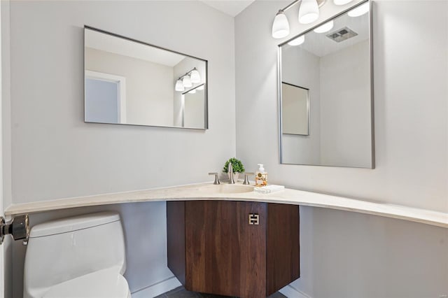 bathroom with vanity and toilet