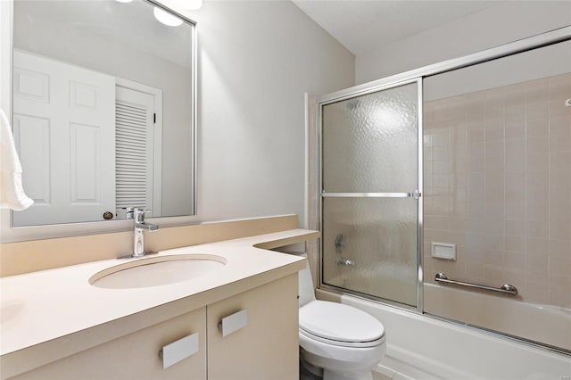 full bathroom with vanity, toilet, and enclosed tub / shower combo