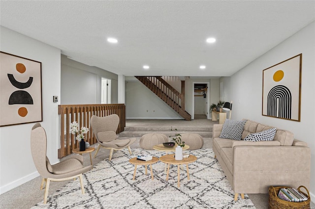 carpeted living room featuring a textured ceiling