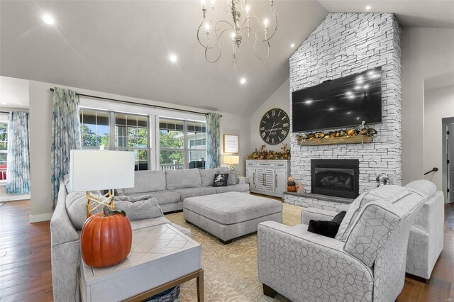 living room with an inviting chandelier, plenty of natural light, and hardwood / wood-style flooring