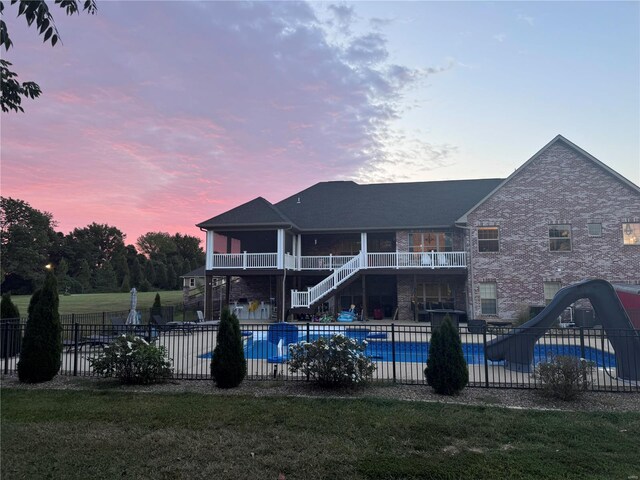 pool at dusk with a water slide