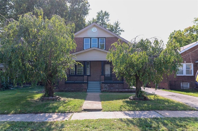 view of front facade with a front yard and a porch