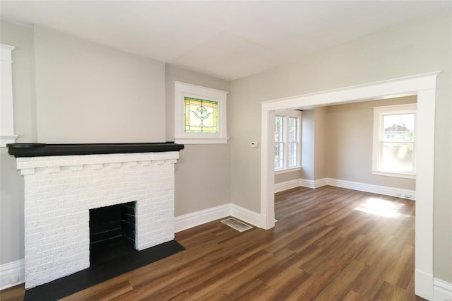 unfurnished living room with a fireplace and dark hardwood / wood-style floors