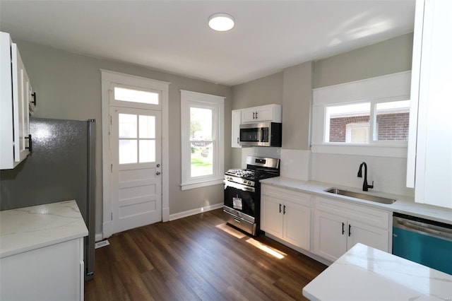 kitchen featuring white cabinetry, sink, stainless steel appliances, and dark hardwood / wood-style flooring