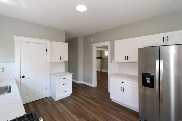 kitchen featuring light stone counters, white cabinets, backsplash, stainless steel refrigerator with ice dispenser, and dark hardwood / wood-style floors