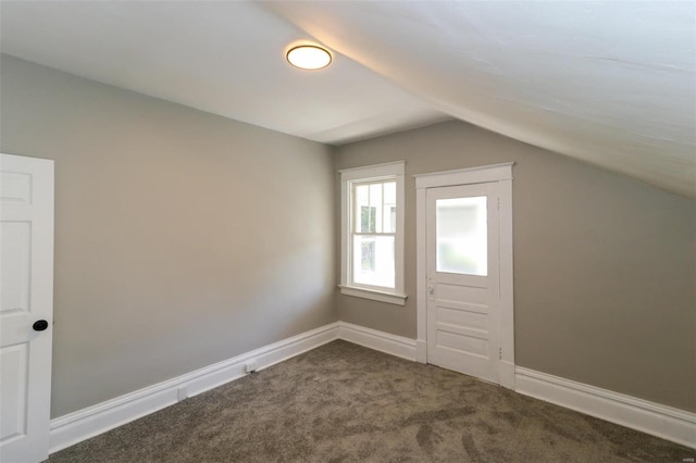 additional living space featuring carpet flooring and vaulted ceiling