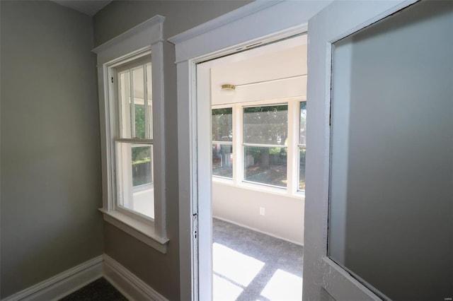 doorway featuring carpet flooring