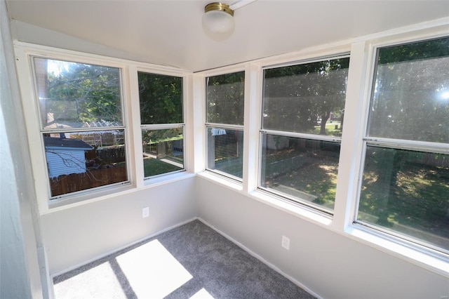 unfurnished sunroom featuring lofted ceiling and a healthy amount of sunlight