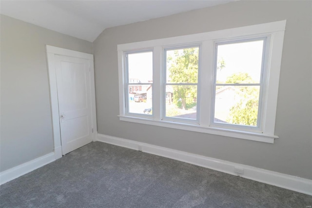 bonus room featuring dark colored carpet and vaulted ceiling