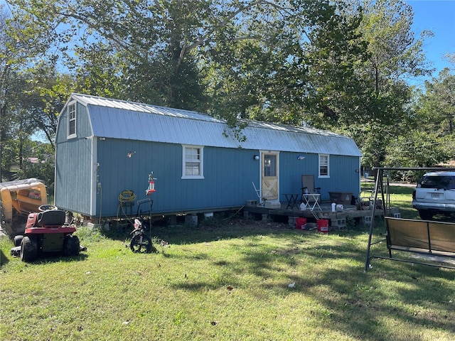 rear view of property featuring a lawn