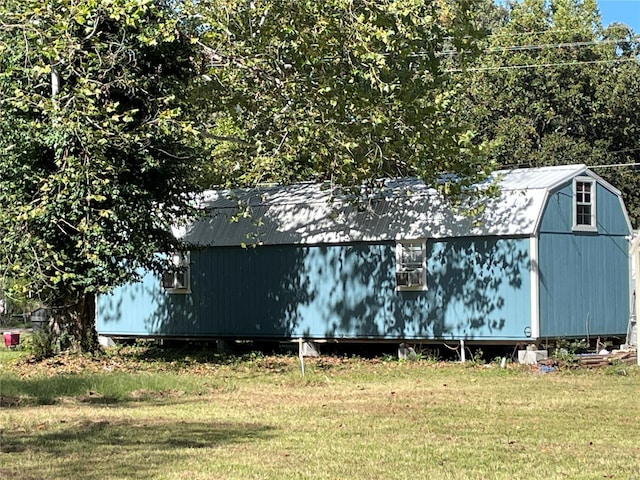 view of outbuilding with a yard