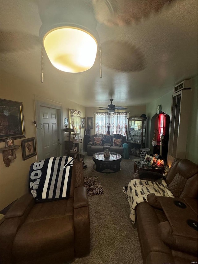 carpeted living room with a textured ceiling and ceiling fan