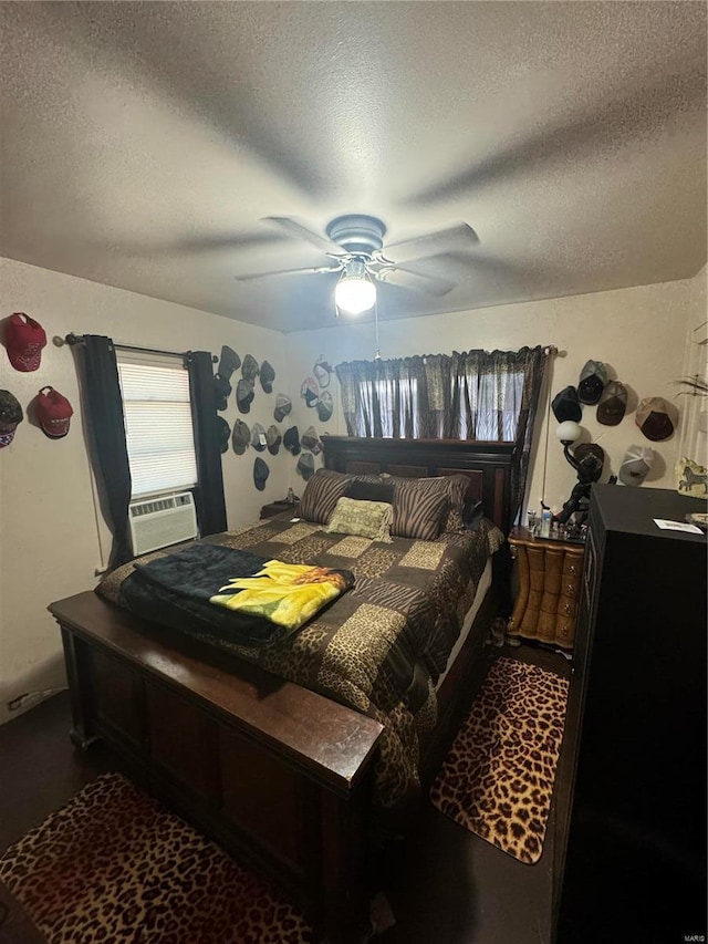 bedroom with ceiling fan, cooling unit, and a textured ceiling