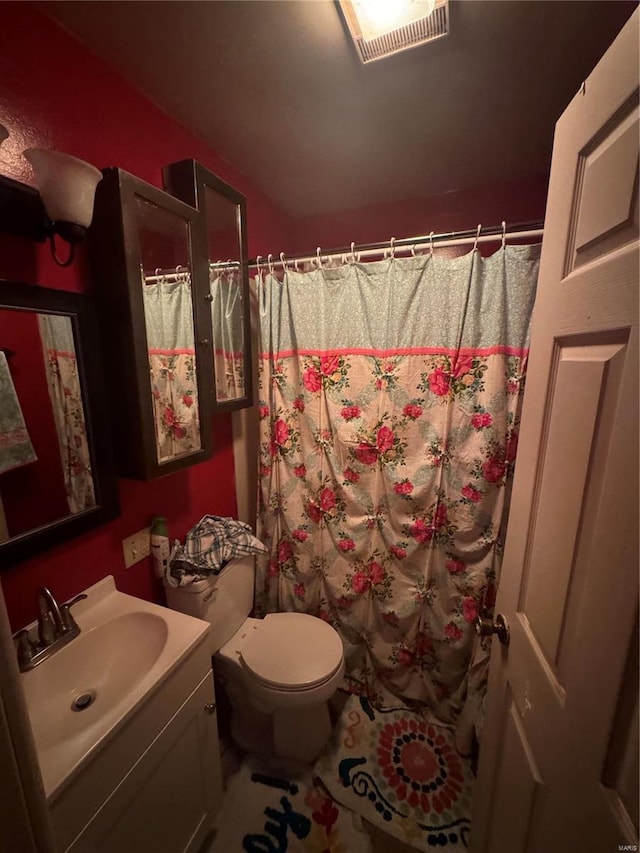 bathroom with vanity, toilet, and a shower with shower curtain