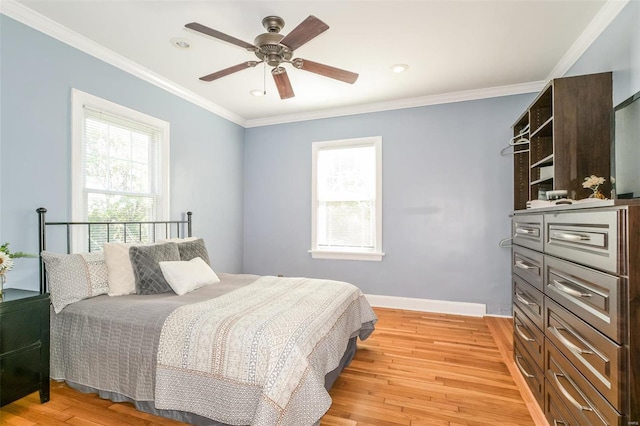 bedroom with ornamental molding, light wood-type flooring, multiple windows, and ceiling fan