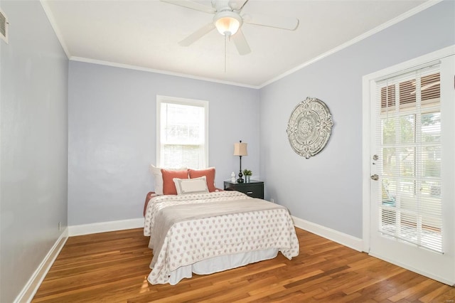 bedroom featuring ceiling fan, hardwood / wood-style flooring, and crown molding