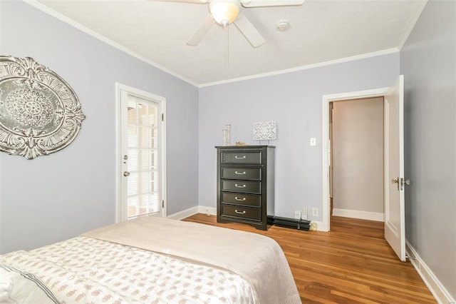 bedroom with crown molding, hardwood / wood-style floors, and ceiling fan