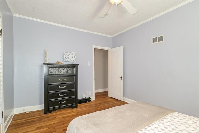 bedroom with ceiling fan, hardwood / wood-style flooring, and ornamental molding