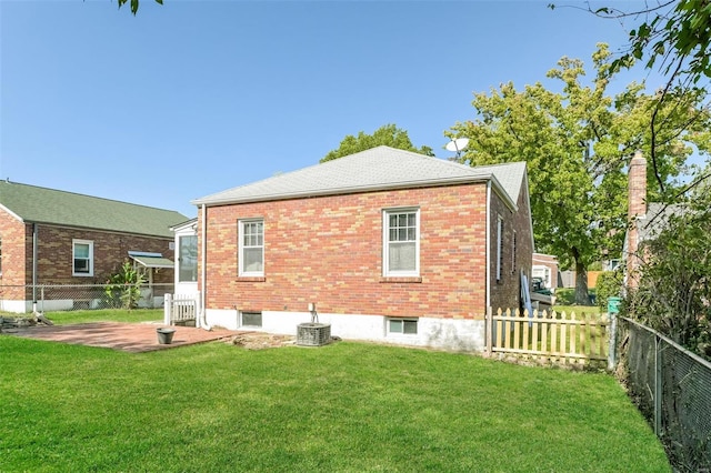 back of property featuring cooling unit, a lawn, and a patio area