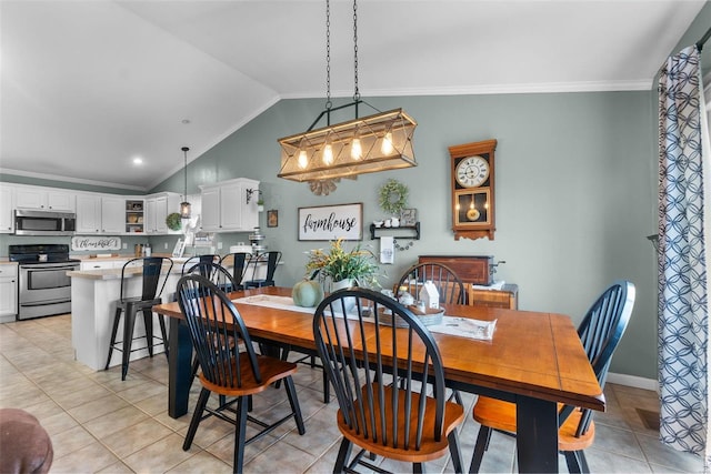 dining room featuring ornamental molding, vaulted ceiling, and light tile patterned floors