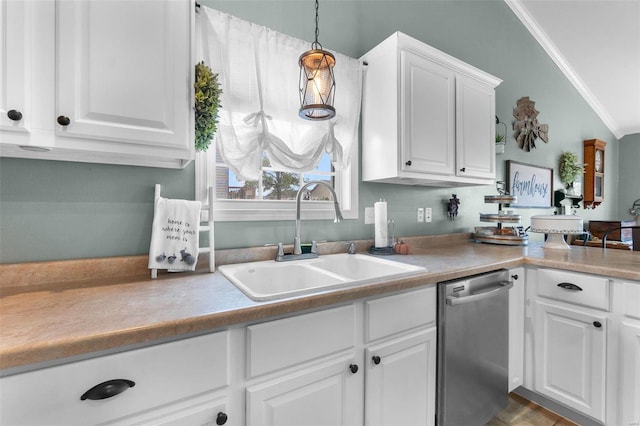 kitchen featuring sink, dishwasher, pendant lighting, white cabinets, and crown molding