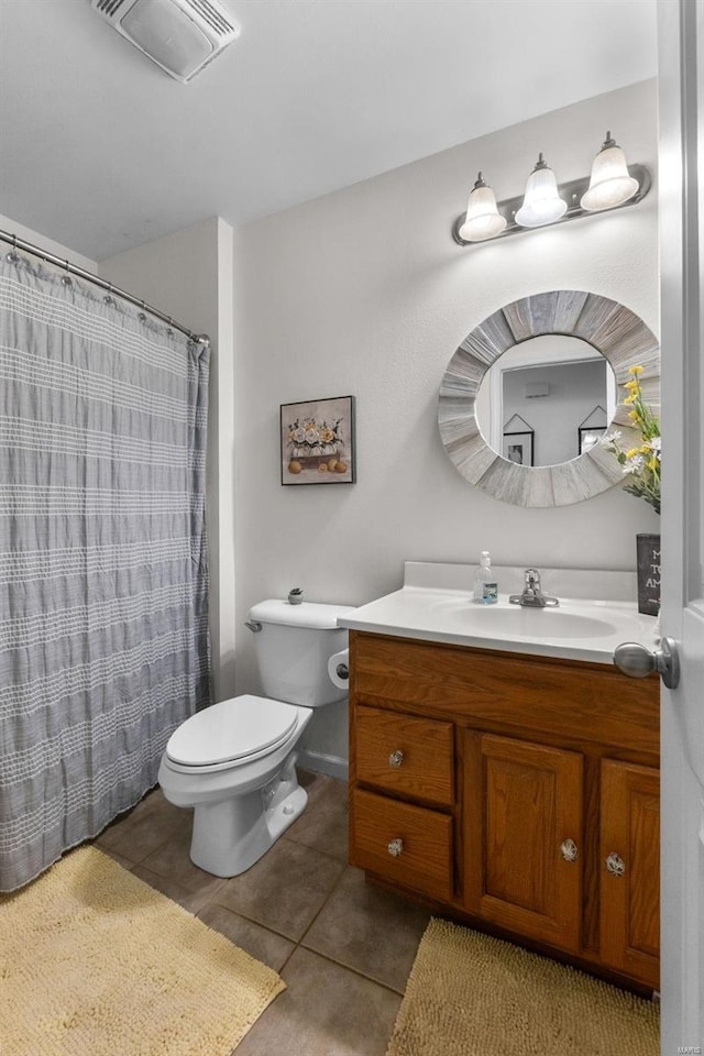 bathroom with vanity, a shower with curtain, toilet, and tile patterned floors