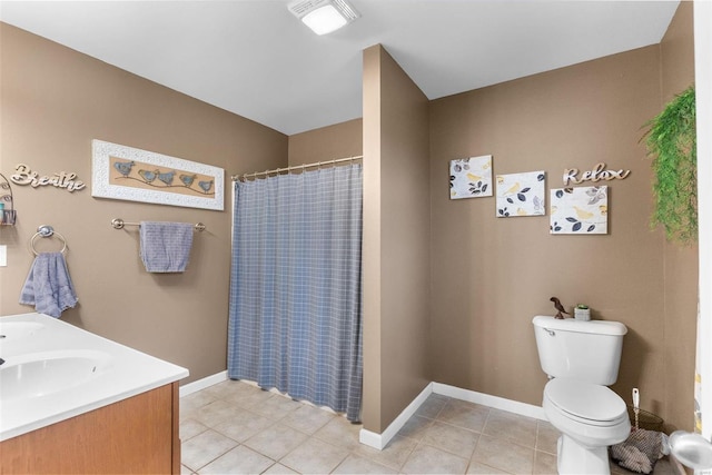 bathroom featuring toilet, vanity, a shower with shower curtain, and tile patterned flooring