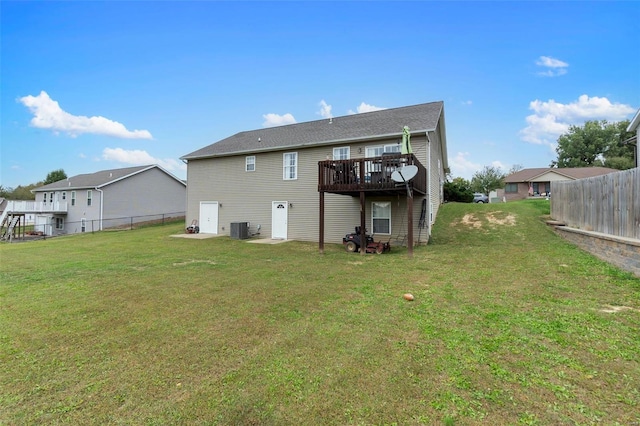 back of house with a deck, a lawn, and central AC unit