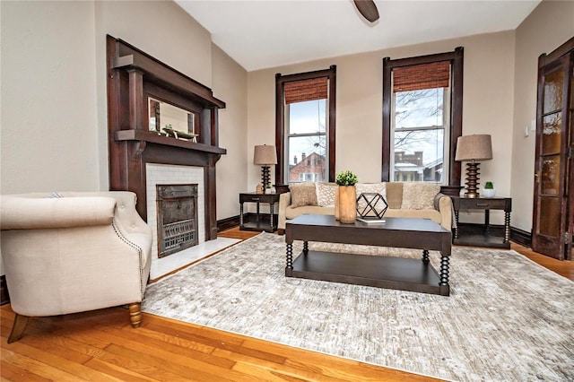 living room with hardwood / wood-style flooring and a brick fireplace