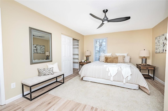 bedroom featuring wood-type flooring, ceiling fan, and a closet