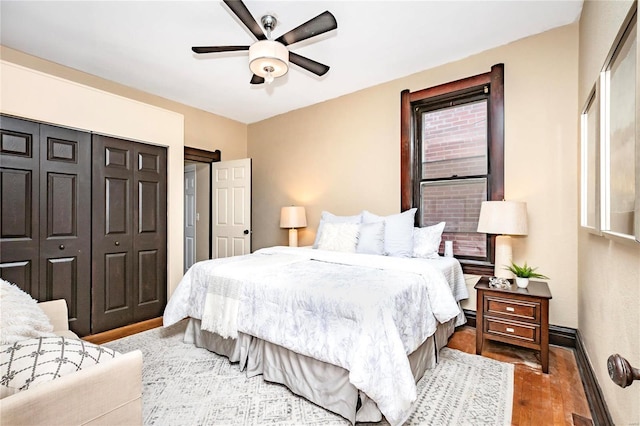 bedroom with dark wood-type flooring and ceiling fan