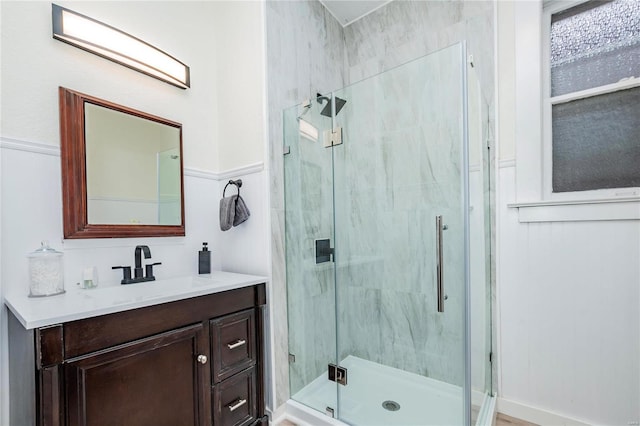 bathroom with vanity and a shower with shower door