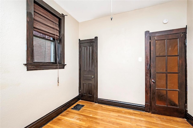 empty room with wood-type flooring