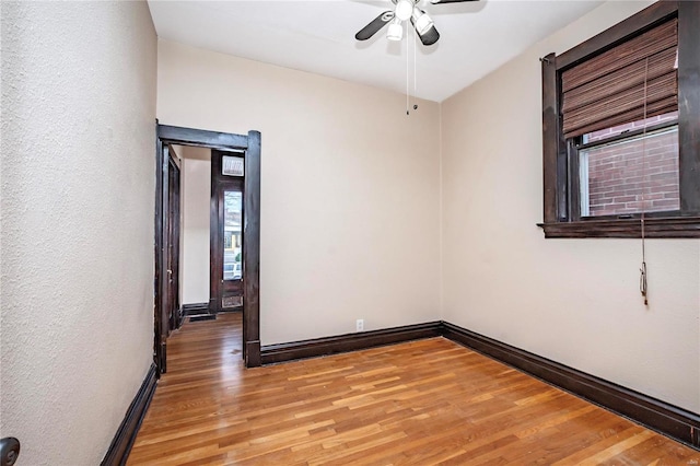 spare room with ceiling fan and light wood-type flooring